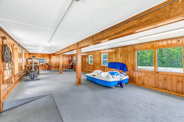 117 Pinkhams Cove Rd, Belgrade, ME 04917 - bedroom with concrete floors, wood walls, and baseboards