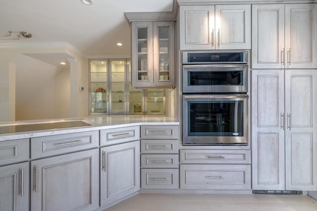 kitchen with stainless steel double oven, glass insert cabinets, gray cabinetry, recessed lighting, and light tile patterned floors
