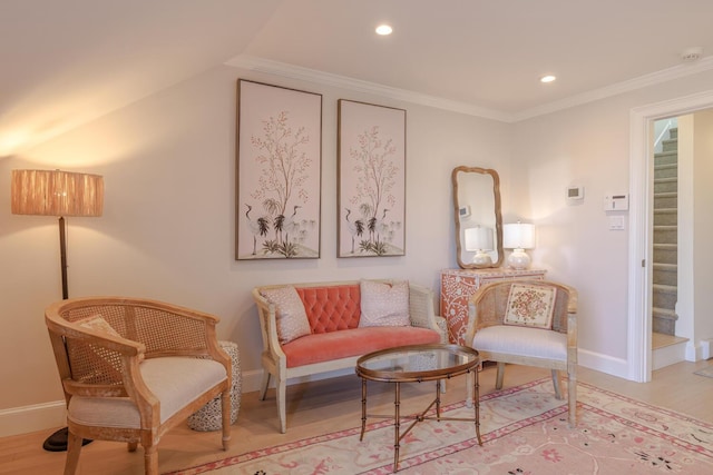 sitting room featuring wood finished floors, baseboards, recessed lighting, stairs, and ornamental molding