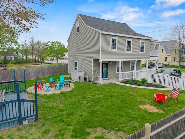107 Elm St, South Portland, ME 04106 - back of house featuring an outdoor fire pit, covered porch, and a shingled roof