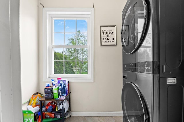 107 Elm St, South Portland, ME 04106 - laundry room with stacked washer and clothes dryer, plenty of natural light, and baseboards