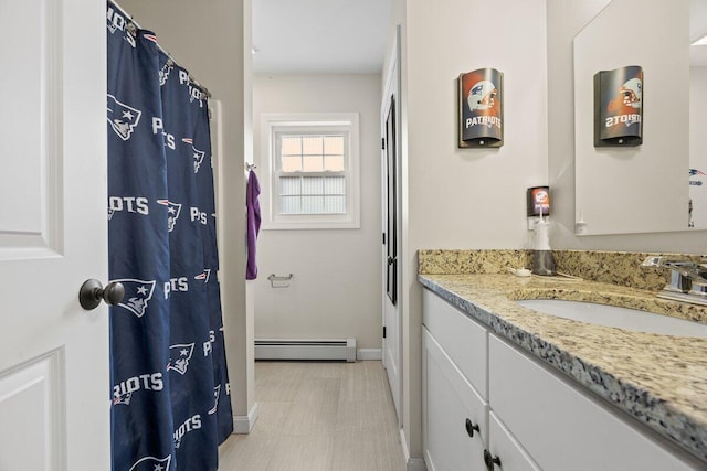 107 Elm St, South Portland, ME 04106 - full bathroom with a baseboard radiator, vanity, and baseboards