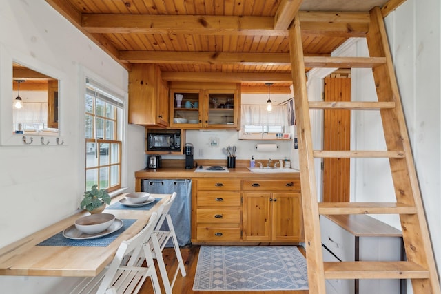 kitchen featuring dishwashing machine, black microwave, a sink, wooden ceiling, and beam ceiling