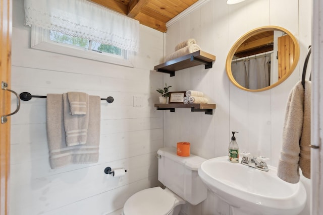 full bath with wooden ceiling, a sink, toilet, wood walls, and curtained shower