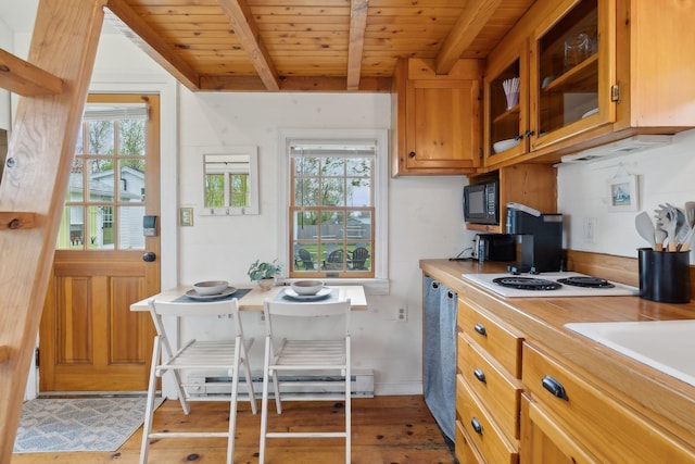 kitchen featuring wooden ceiling, beam ceiling, healthy amount of natural light, light countertops, and light wood finished floors