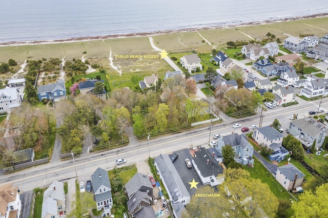 aerial view of property and surrounding area with nearby suburban area and expansive coastline