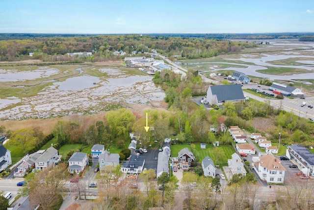 aerial view of property's location featuring a nearby body of water and nearby suburban area
