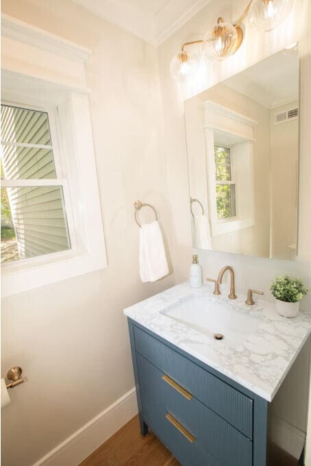 104 Woodbridge Rd, York, ME 03909 - bathroom with vanity, wood finished floors, baseboards, and ornamental molding