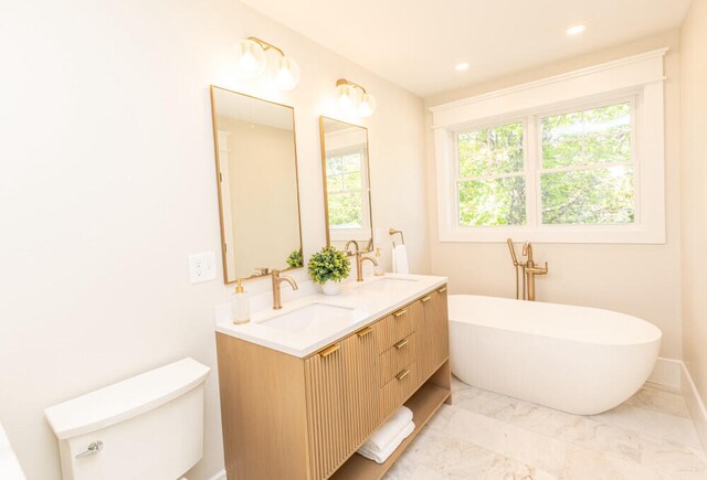 104 Woodbridge Rd, York, ME 03909 - full bath with toilet, a freestanding tub, double vanity, marble finish floors, and recessed lighting