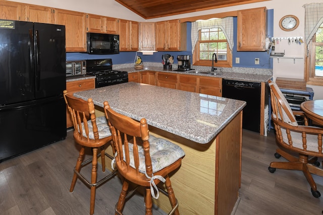 19 Pine Acres Dr, Cornish, ME 04020 - kitchen with black appliances, a sink, vaulted ceiling, dark wood-style floors, and brown cabinetry