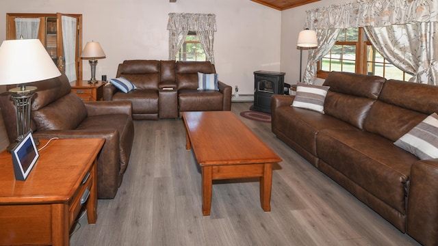 19 Pine Acres Dr, Cornish, ME 04020 - living room with wood finished floors, a wood stove, crown molding, and baseboard heating