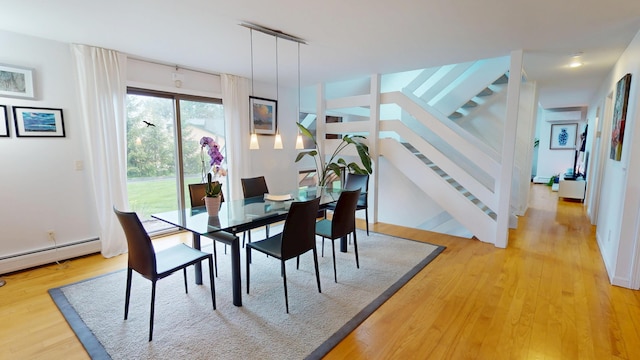 28 Meadow Ln, Brewer, ME 04412 - dining space featuring light wood-style flooring, stairs, and a baseboard heating unit