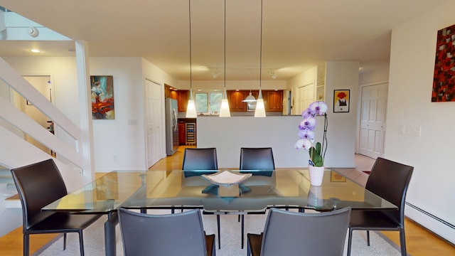 28 Meadow Ln, Brewer, ME 04412 - dining space with a baseboard radiator, light wood finished floors, and stairs