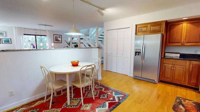 28 Meadow Ln, Brewer, ME 04412 - dining area with rail lighting, light wood finished floors, stairs, and baseboards