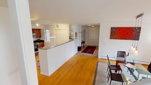 28 Meadow Ln, Brewer, ME 04412 - corridor featuring light wood finished floors, rail lighting, and baseboard heating