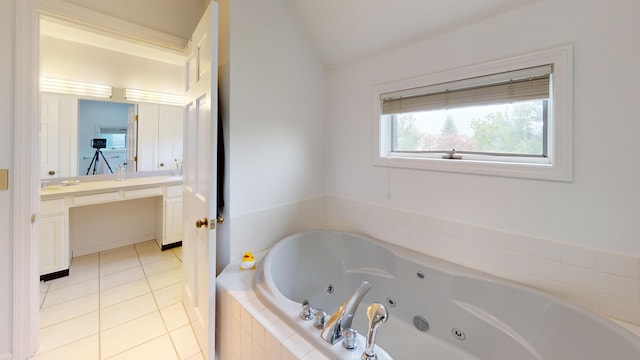 28 Meadow Ln, Brewer, ME 04412 - full bathroom with a tub with jets, vanity, vaulted ceiling, and tile patterned floors