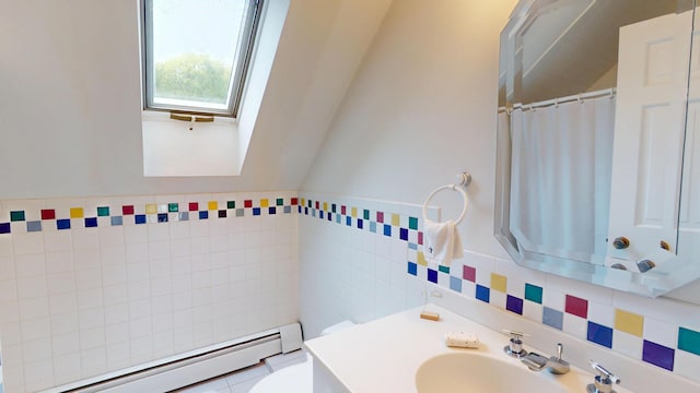 28 Meadow Ln, Brewer, ME 04412 - bathroom with a baseboard radiator, tile walls, a skylight, toilet, and vanity