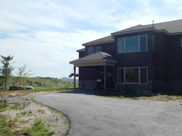 80 Pasture Ln, Brownfield, ME 04010 - view of property exterior featuring stone siding and roof with shingles