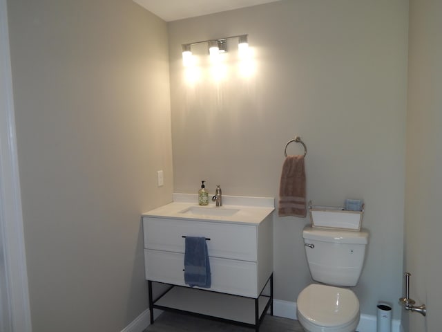 80 Pasture Ln, Brownfield, ME 04010 - half bathroom featuring toilet, vanity, and baseboards