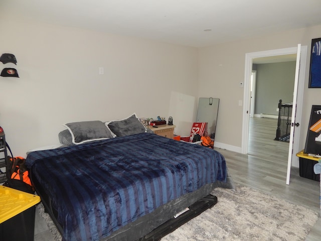 80 Pasture Ln, Brownfield, ME 04010 - bedroom with wood finished floors, a baseboard heating unit, and baseboards
