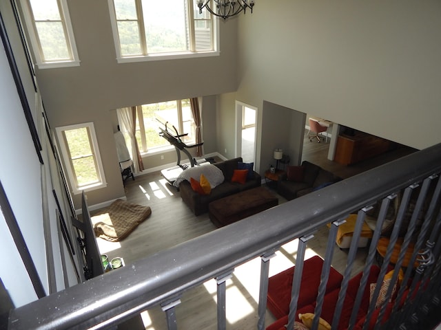 80 Pasture Ln, Brownfield, ME 04010 - stairs with a towering ceiling, wood finished floors, a chandelier, and baseboards