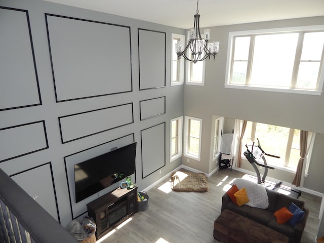 80 Pasture Ln, Brownfield, ME 04010 - living room featuring a chandelier, wood finished floors, and baseboards