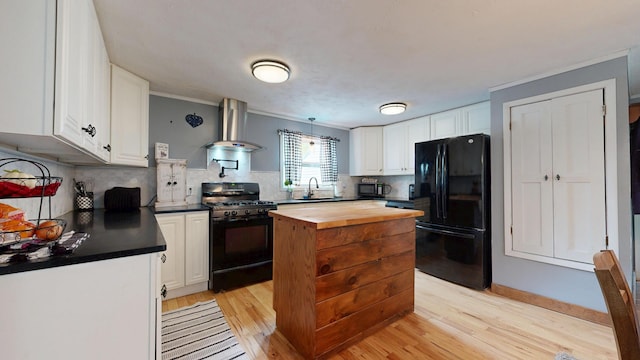 76 School St, Baldwin, ME 04024 - kitchen with black appliances, wooden counters, wall chimney exhaust hood, and light wood finished floors