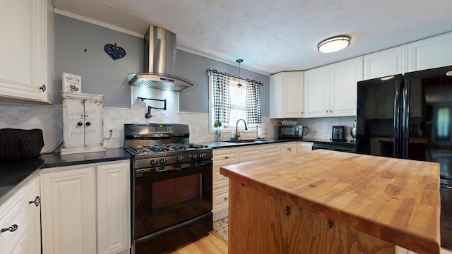 76 School St, Baldwin, ME 04024 - kitchen with wall chimney exhaust hood, black appliances, a sink, wooden counters, and crown molding