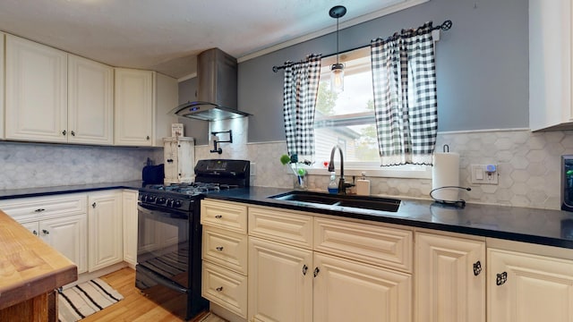 76 School St, Baldwin, ME 04024 - kitchen featuring black range with gas stovetop, a sink, dark countertops, wall chimney range hood, and backsplash