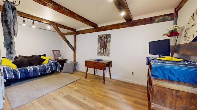 76 School St, Baldwin, ME 04024 - bedroom featuring beam ceiling, light wood-style flooring, baseboards, and track lighting