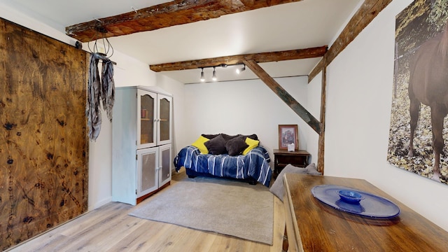 76 School St, Baldwin, ME 04024 - bedroom featuring beamed ceiling and light wood finished floors