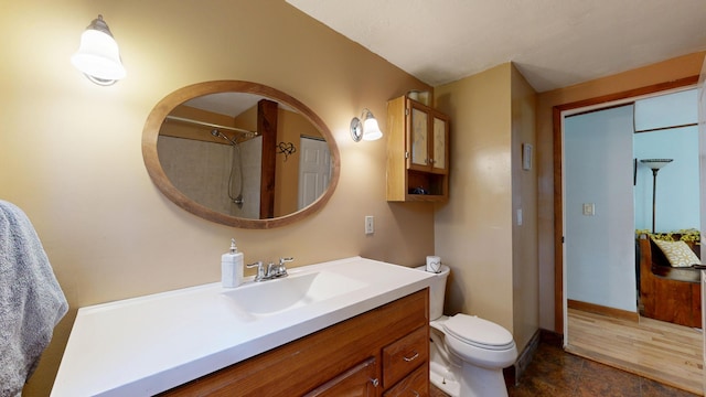76 School St, Baldwin, ME 04024 - bathroom with vanity, toilet, baseboards, and a shower