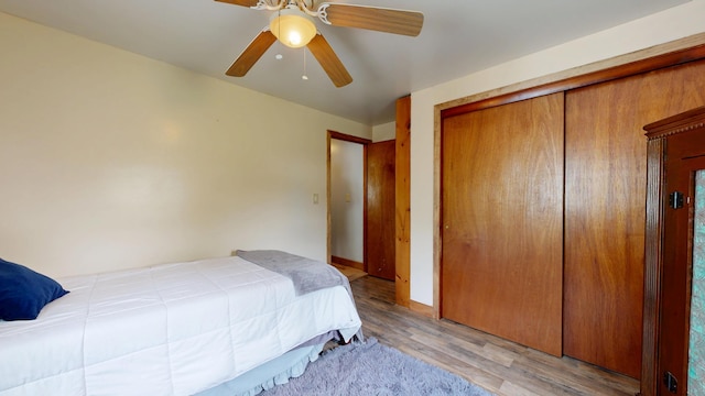 76 School St, Baldwin, ME 04024 - bedroom featuring a closet, light wood-style floors, and a ceiling fan