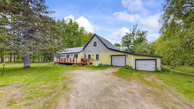 76 School St, Baldwin, ME 04024 - view of front of home featuring dirt driveway, a wooden deck, a front yard, and a garage