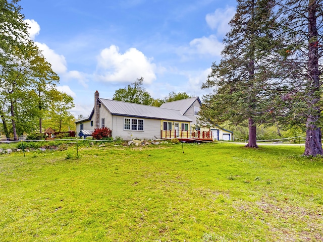 76 School St, Baldwin, ME 04024 - rear view of property featuring a chimney, a wooden deck, and metal roof