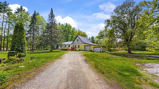 76 School St, Baldwin, ME 04024 - bungalow-style home featuring dirt driveway, a garage, a deck, and a front yard