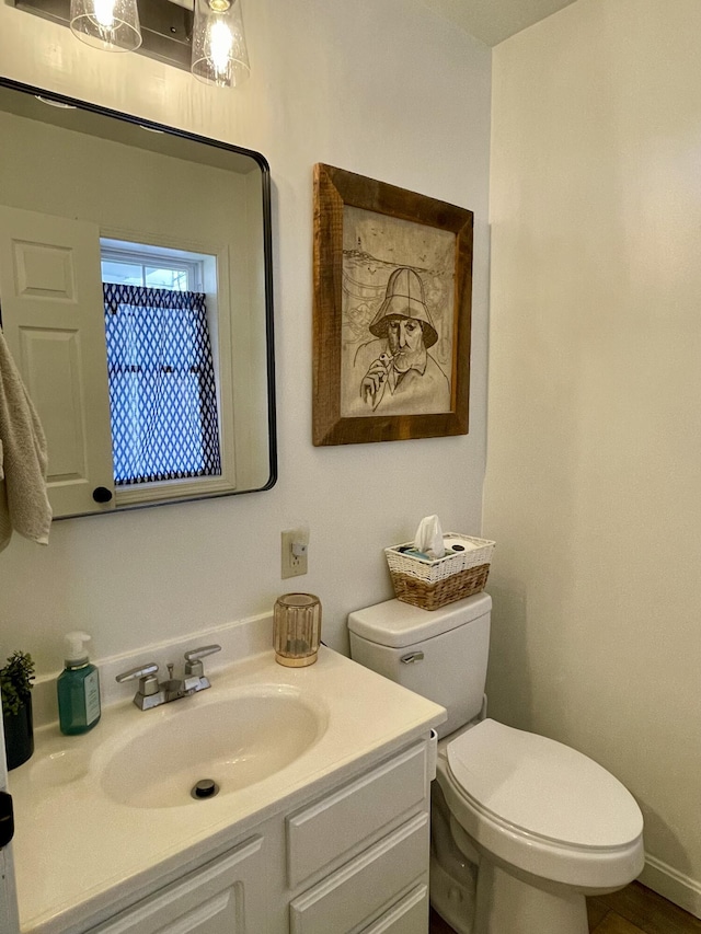 bathroom featuring toilet and vanity