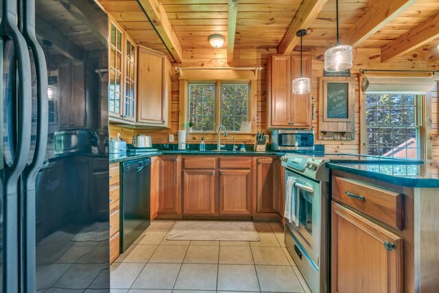 kitchen featuring black appliances, beamed ceiling, light tile patterned flooring, a sink, and healthy amount of natural light