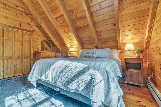 bedroom with a baseboard heating unit, wooden ceiling, wooden walls, and light wood-style flooring