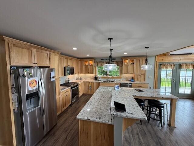 1027 Gardner Creek Rd, Wade, ME 04786 - kitchen with stainless steel refrigerator with ice dispenser, black microwave, gas stove, french doors, and a large island