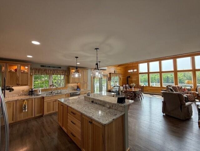 1027 Gardner Creek Rd, Wade, ME 04786 - kitchen featuring open floor plan, dark wood-type flooring, a kitchen island, recessed lighting, and light stone countertops