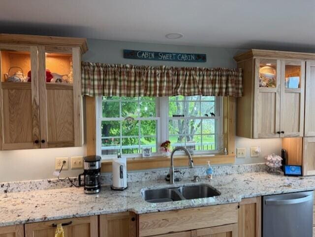 1027 Gardner Creek Rd, Wade, ME 04786 - kitchen with stainless steel dishwasher, glass insert cabinets, and light stone countertops