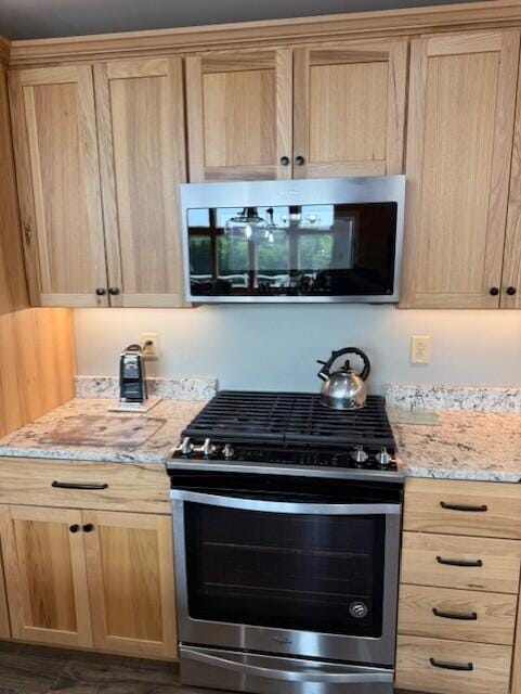 1027 Gardner Creek Rd, Wade, ME 04786 - kitchen with appliances with stainless steel finishes, light brown cabinets, and light stone counters
