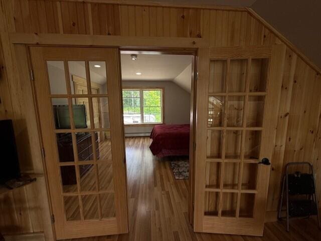 1027 Gardner Creek Rd, Wade, ME 04786 - bedroom featuring vaulted ceiling, wood finished floors, and wooden walls