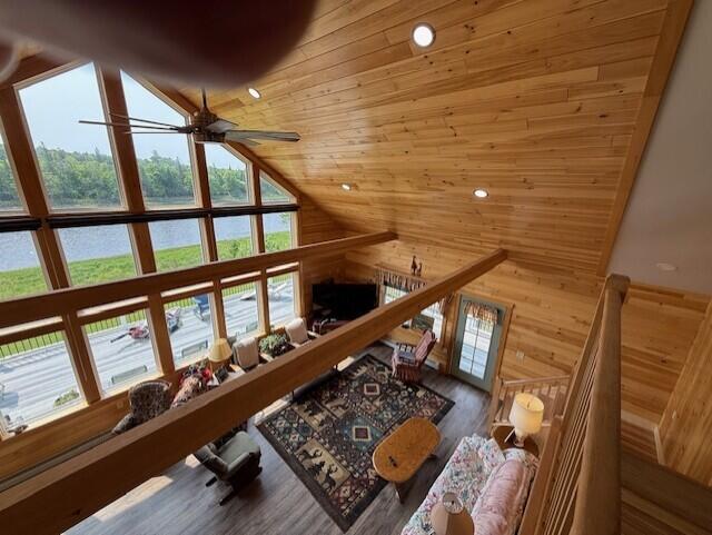 1027 Gardner Creek Rd, Wade, ME 04786 - living room with high vaulted ceiling, a ceiling fan, wooden walls, plenty of natural light, and wood ceiling