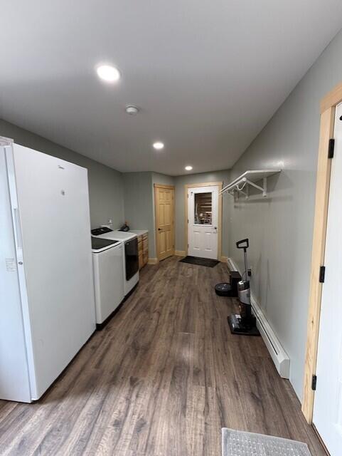 1027 Gardner Creek Rd, Wade, ME 04786 - kitchen featuring washing machine and dryer, wood finished floors, freestanding refrigerator, recessed lighting, and baseboard heating