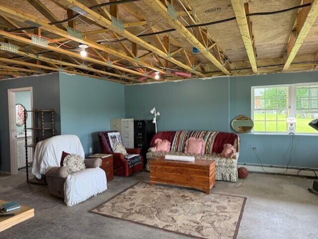 1027 Gardner Creek Rd, Wade, ME 04786 - living room with a baseboard radiator and unfinished concrete floors