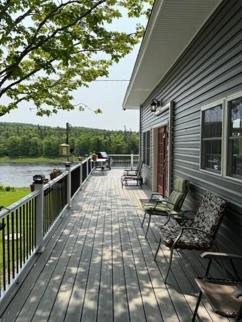 1027 Gardner Creek Rd, Wade, ME 04786 - wooden deck with a water view and a wooded view