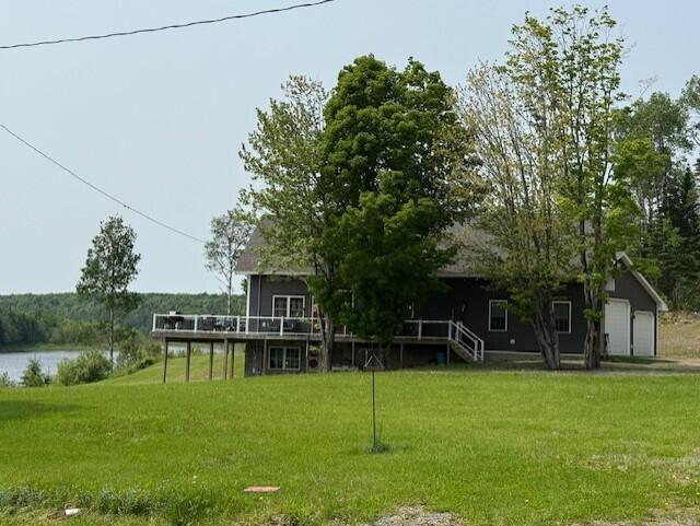1027 Gardner Creek Rd, Wade, ME 04786 - view of grassy yard with a deck with water view and a garage