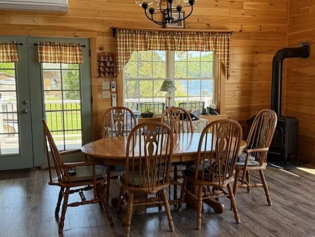 1027 Gardner Creek Rd, Wade, ME 04786 - dining area featuring wooden walls, plenty of natural light, wood finished floors, and a chandelier